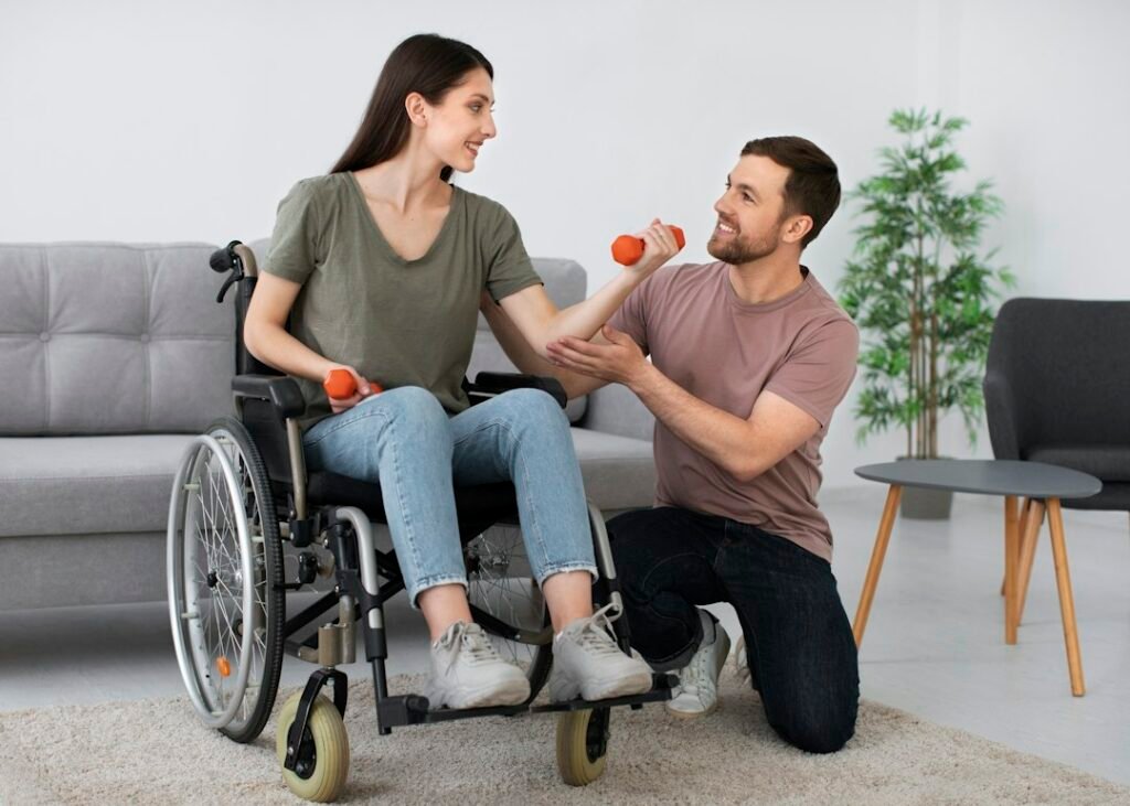 Mujer en silla de ruedas realizando ejercicios con apoyo de otra persona en el salón de una vivienda.